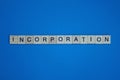 Gray word incorporation in small square wooden letters