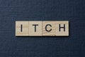 Gray word itch from small wooden letters