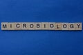 Gray word microbiology from small wooden letters