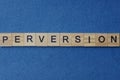 Gray word perversion in small square wooden letters