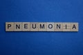 Gray word pneumonia from small wooden letters