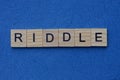 Gray word riddle from small wooden letters