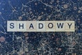 Gray word shadowy from wooden letters in black font