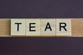 Gray word tear made of wooden square letters