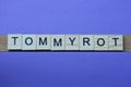 Gray word tommyrot in small square wooden letters