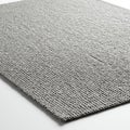 Gray woven textile displaying a textured surface with a tightly interlaced pattern. The Royalty Free Stock Photo