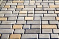 Gray and yellow pavement bricks for pavement road on the floor. Defocus brick tiles background. Stack paving stones