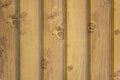 Gray yellow wooden wall of planks with cracks and shadows. vertical lines. natural surface texture Royalty Free Stock Photo