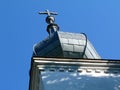 Gray zink cladded church clock tower. onion shaped segmented cupola