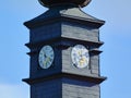 Gray zink covered clock tower. white clock face. golden clock hands