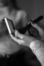 Grayscale shot of a female applying makeup with a brush