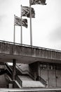 Grayscale of an abandoned building with stairways and old flags, vertical shot