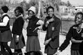 Grayscale of African high school pupils messing about on the sports field Royalty Free Stock Photo