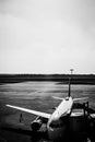 Grayscale of an airplane landed on the runway on a bright day - a concept of fast travel