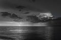 Grayscale of Baltic sea at night with a flash of lightning in the gloomy clouds with long exposure
