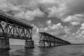 Grayscale of a bridge in Maraton, Keys island, Florida under a cloudy sky Royalty Free Stock Photo