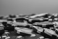 Grayscale closeup of a pile of poker chips on the table