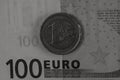 Grayscale closeup shot of details on a hundred Euro banknote and a one euro coin Royalty Free Stock Photo