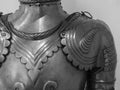 Grayscale closeup shot of the details of a medieval knight armor