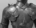 Grayscale closeup shot of the details of a medieval knight armor