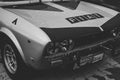 Grayscale closeup shot of an old-school fiat race car.