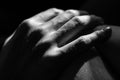 Grayscale closeup shot of a person's hand on a blurred background