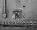 Grayscale closeup shot of a steel faucet on a metal surface