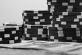 Grayscale closeup of a stack of poker chips on the table