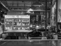 Grayscale of a fish market with fridges and pictures on the wall in Vancouver, Canada