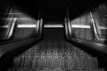 grayscale high angel shot of escalator in modern buildings