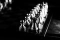 Grayscale high-angle shot of a Chess board with the pieces on top