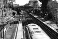 Grayscale high angle shot of an outdoor train station.