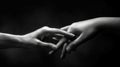 A grayscale image of two hands reaching out to each other on a black back ground AIG535