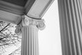 Grayscale low angle shot of ionic pillars of a mansion Royalty Free Stock Photo