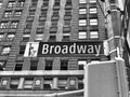 Grayscale low-angle shot of a street sign with a direction to Broadway in New York Royalty Free Stock Photo