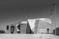 Grayscale of Magma center in Costa Adeje with sky and metal street lights, Tenerife