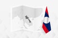 A grayscale map of Laos with a hanging Laotian flag on one side. Vector map for many types of news