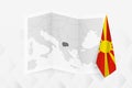 A grayscale map of North Macedonia with a hanging Macedonian flag on one side. Vector map for many types of news