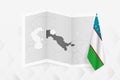 A grayscale map of Uzbekistan with a hanging Uzbekistani flag on one side. Vector map for many types of news
