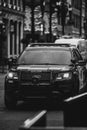 Grayscale of a marked police Ford Explorer parked on a street