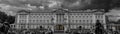 Grayscale panoramic shot of the crowd at the entrance of Buckingham Palace. London, England.