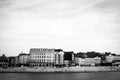 Grayscale panoramic shot of residential buildings of a city by a river
