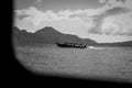 Grayscale picture of a motorboat sailing on Lake Atitlan, SololÃÂ¡, Guatemala