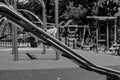 Grayscale selective focus shot of children\'s slide park
