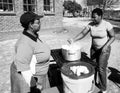 Grayscale shot of African women cooking maize porridge in the street Royalty Free Stock Photo