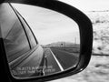 Grayscale shot of the car wing mirror on a road trip in Arizona, USA Royalty Free Stock Photo