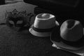 Grayscale shot of carnival mask and straw hats