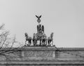 Grayscale shot of the chariot statue on the Brandenburg Gate in Berlin, Germany under a clear sky Royalty Free Stock Photo