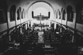 Grayscale shot of a church with a cross during a worship night. Kampala, Uganda