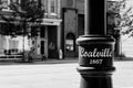 Grayscale shot of a city light pole on the quiet weekend streets of Coalville, UT